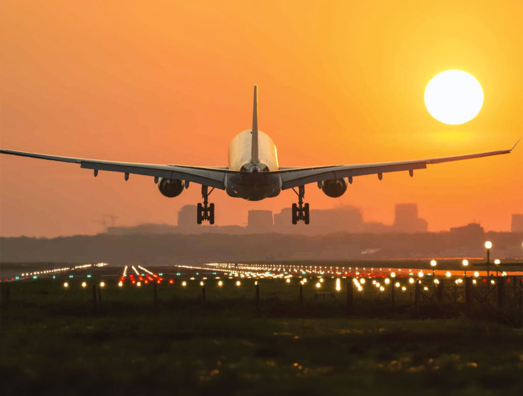 Commercial airplane taking off on a runway against a clear sky.